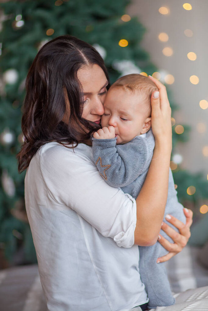 mom hugs her newborn son at home - Valokuva, kuva