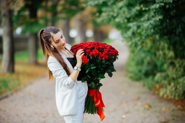 womans hand is holding a bouquet of flowers. - Photo, image
