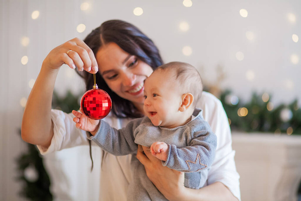 young mother and little son playing christmas toys - Фото, зображення