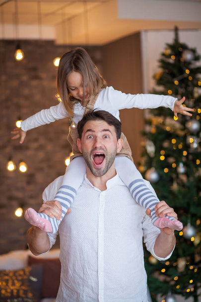happy young dad tosses daughter are laughing - Foto, imagen