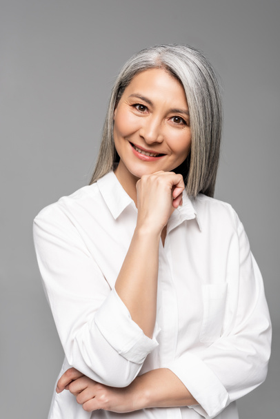 smiling asian woman with grey hair isolated on grey - Фото, зображення