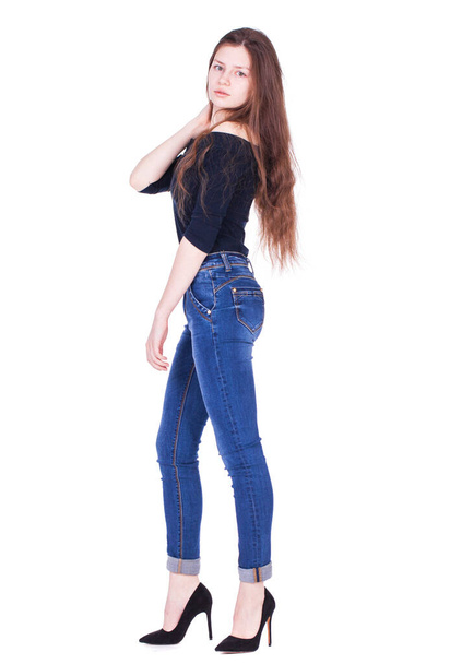 Full body portrait of a young beautiful brunette model in blue jeans, isolated on white background - Φωτογραφία, εικόνα