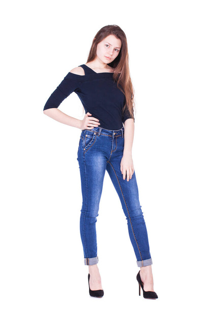 Full body portrait of a young beautiful brunette model in blue jeans, isolated on white background - Foto, Imagen