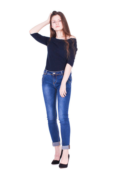 Full body portrait of a young beautiful brunette model in blue jeans, isolated on white background - Zdjęcie, obraz