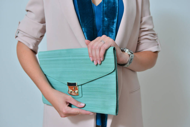 Fashionable turquoise stylish bag in a hand - Photo, Image