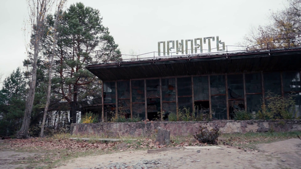 CHERNOBYL, UKRAINE - NOVEMBER 6, 2019: abandoned building with Pripyat lettering - Felvétel, videó