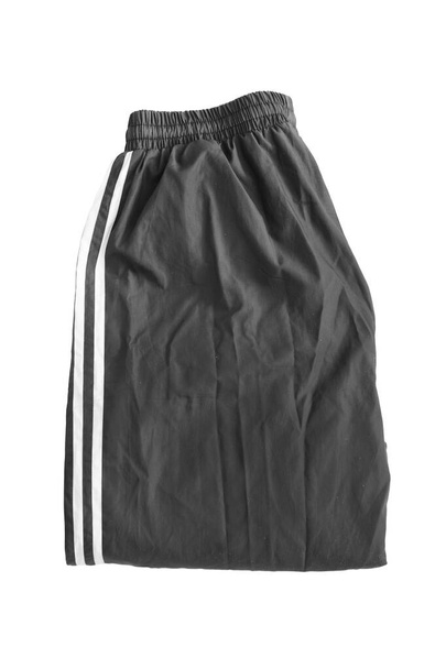 Black sport pants folded on white background - Foto, afbeelding