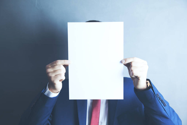 businessman hand empty paper in face - Фото, зображення