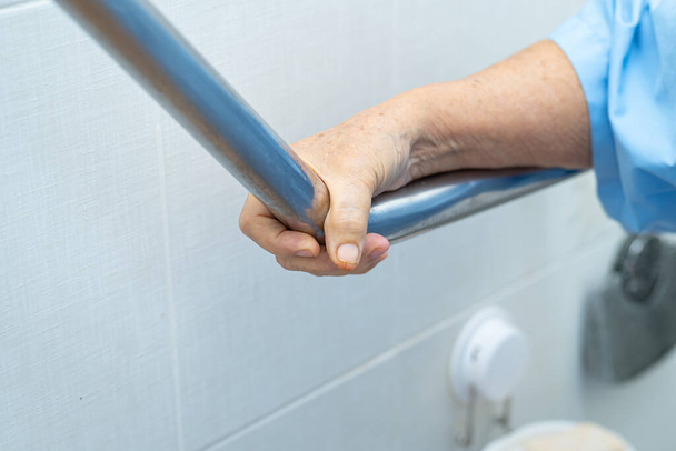 Asian senior or elderly old lady woman patient use toilet bathroom handle security in nursing hospital ward : healthy strong medical concept. - Photo, Image