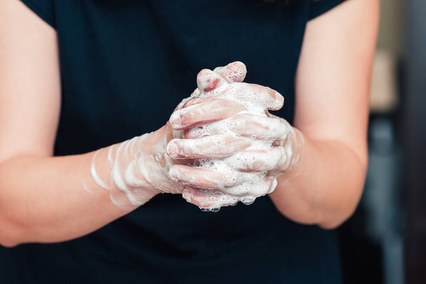 Front view on womans hands with soap foam, personal hygiene concept - Foto, afbeelding