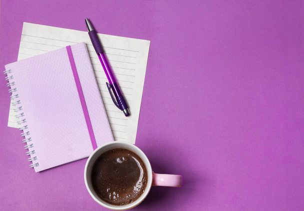 coffee, notebook and pen on a lilac background - Φωτογραφία, εικόνα