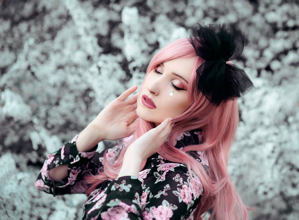 Portrait of young woman with pink hair  posing in park  - Photo, Image