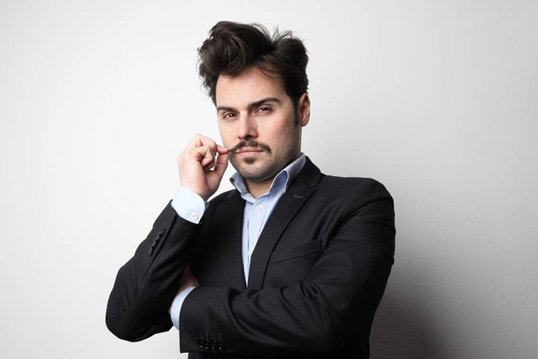 Young bearded man wearing suit posing at the white background. Horizontal. - Φωτογραφία, εικόνα