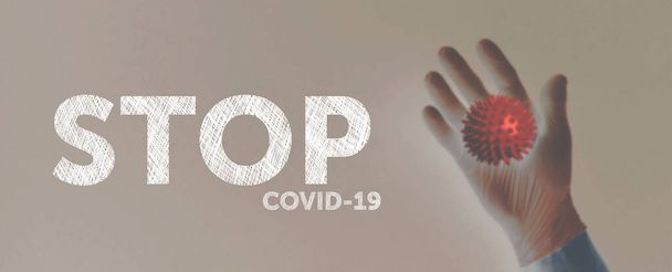 hand in medical gloves shows virus stop covid19 - Foto, afbeelding