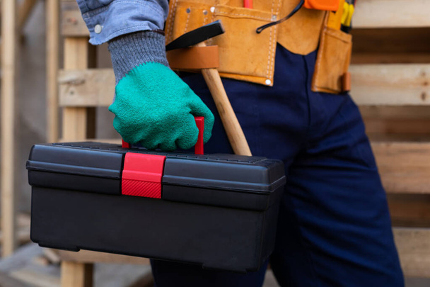 Close up picture of carpenters tool belt and work instruments on wooden background - Foto, Imagem