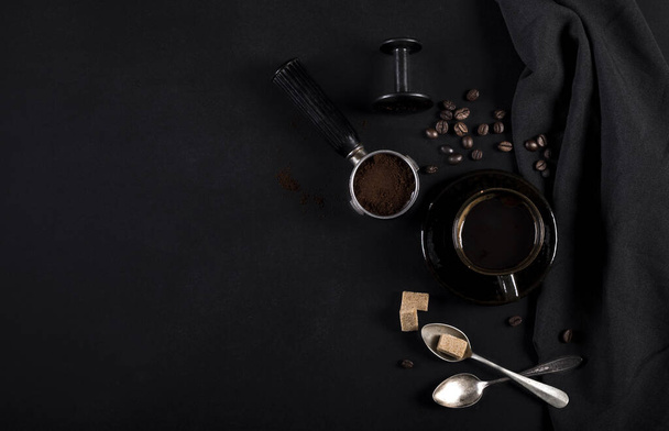 Coffee and utensils for coffee maker on a black background with copy space for text - Zdjęcie, obraz