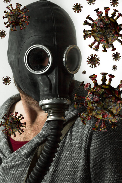 致命的なコロナウイルス感染に対する保護としてガスマスクを身に着けている男 - 写真・画像