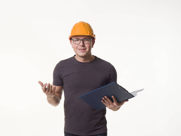 young man - worker in a helmet with a folder - Foto, Imagem