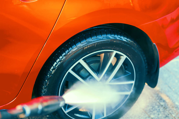 Car wash, care and cleaning. Washing alloy wheels with external high pressure washer. - Фото, изображение