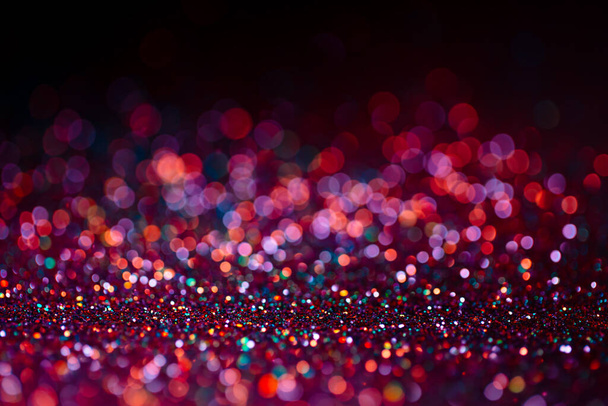 Decoration bokeh glitters background, abstract shiny backdrop with circles,modern design overlay with sparkling glimmers. Black, pink and orange backdrop glittering sparks with glow effect. - Photo, image