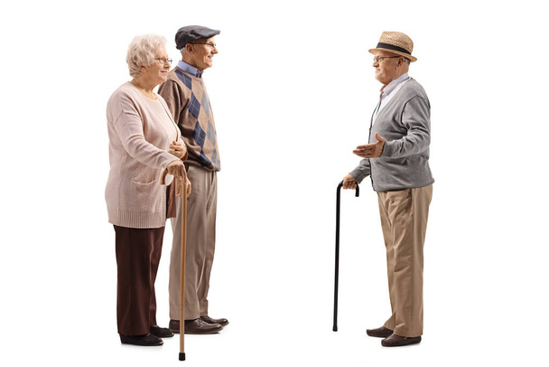 Edlerly man and woman talking to another senior man isolated on white background - Fotoğraf, Görsel