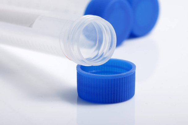 Close up shot of empty plastic test tube with blue lid for medical and laboratory testing purpose - Foto, imagen