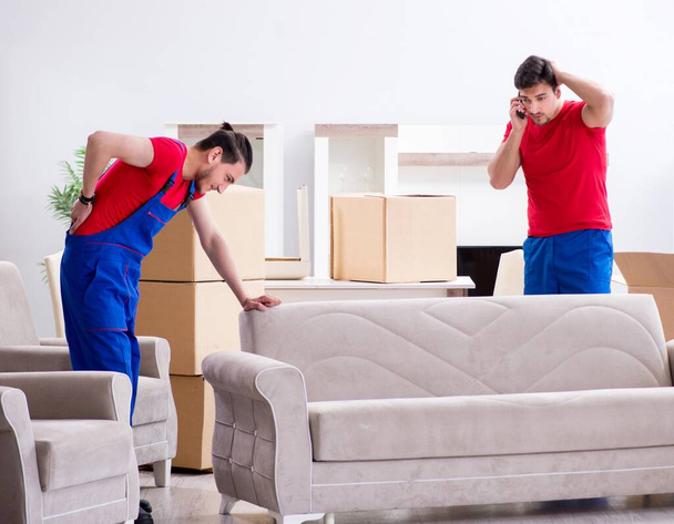 Two contractor employees moving personal belongings - Fotó, kép