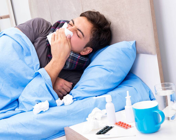 Sick man with flu lying in the bed - Photo, Image