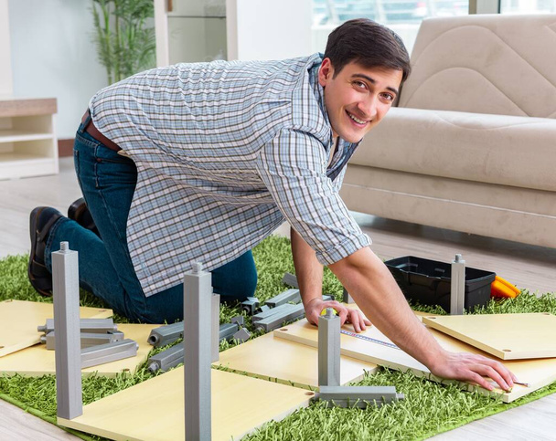 Man monteert meubels thuis - Foto, afbeelding
