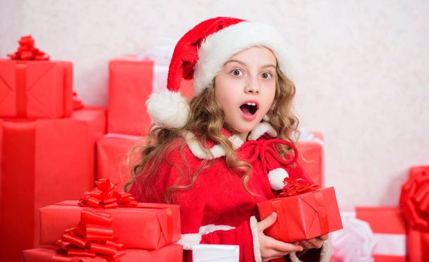 Girl celebrate christmas. Santa bring her gift. Winter happiness concept. Explore christmas gifts. Unpacking christmas gift. New year holiday tradition. Kid excited about opening christmas present - Photo, image