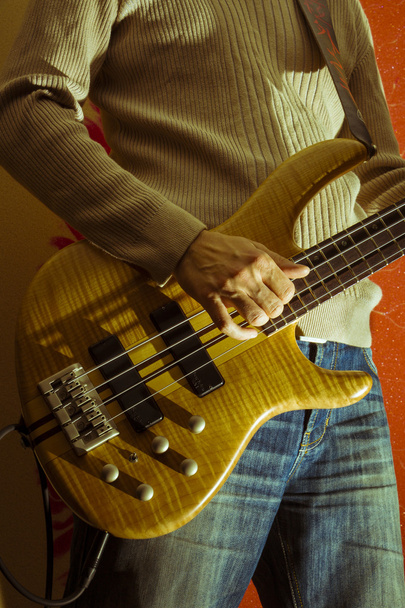 Young man with a bass guitar - Photo, Image