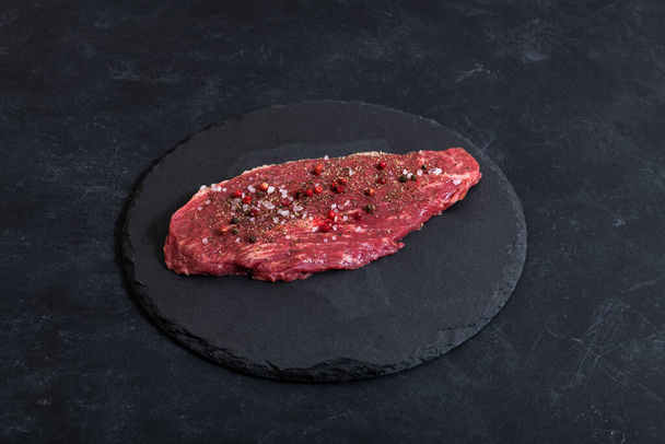 Raw fresh marbled meat and seasonings on dark background top view - Photo, Image