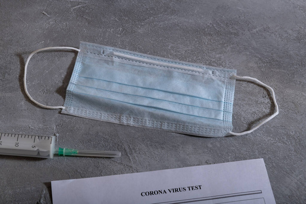 Protective medical mask and Coronavirus test paper form. Coronavirus concept. COVID-19 - Foto, Imagem