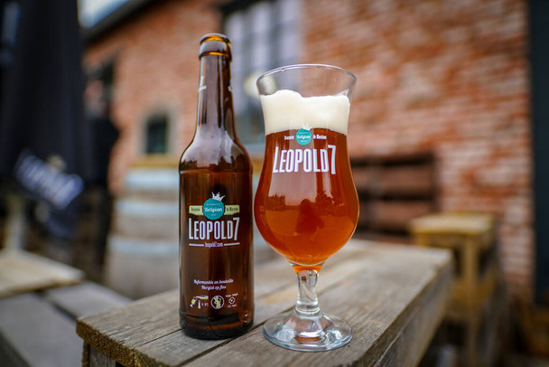 HERON, BELGIUM - NOVEMBER 9, 2019: Belgian Leopold 7 beer, bottle and glass. Premium craft beer made of 3 hops and the Leopold Touch. Belgian beer brewery. - Foto, afbeelding