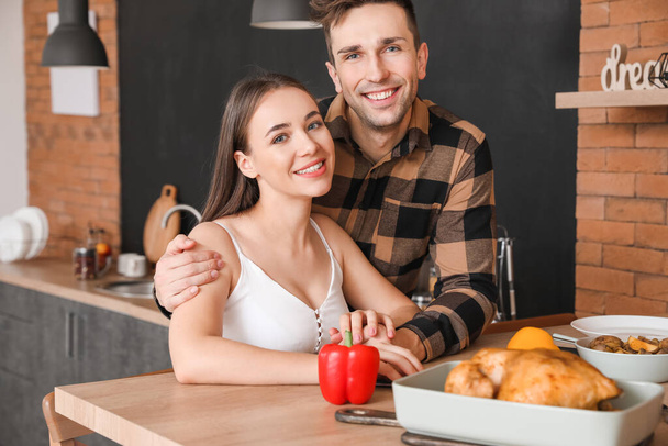 Young couple having dinner in kitchen - Photo, Image