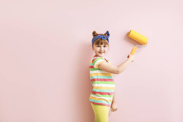Little girl painting wall in room - Photo, Image