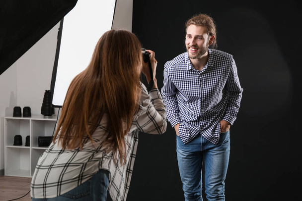Professional photographer working with model in studio - Photo, Image