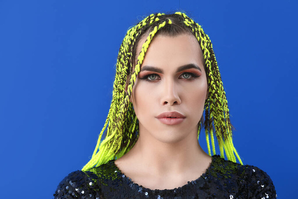 Portrait of young transgender woman on color background - Photo, Image