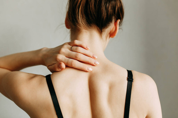  Neck and back injuries, and fatigue at work. The zone of injury, the image on a blank background. A spasm in the girl's neck. - Valokuva, kuva