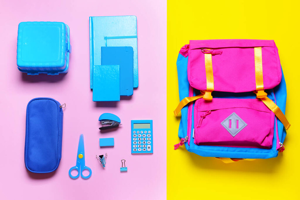 School backpack and stationery on color background - Photo, Image