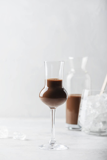 Sweet chocolate liqueur on thw light table, selective focus image - Foto, afbeelding