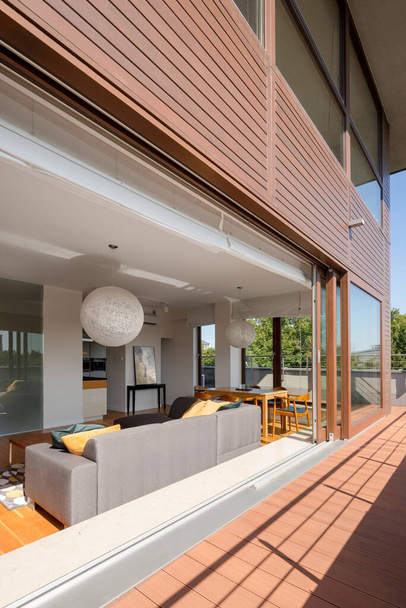 Modern apartment with stylish living room open to big balcony - Фото, зображення
