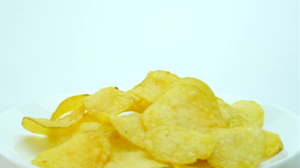 Crispy potato chips on a white plate. Close-up. 360 rotation. - Felvétel, videó