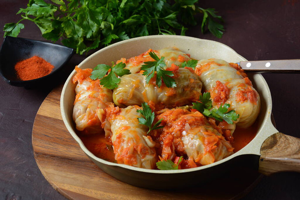 Cabbage rolls stuffed with ground beef and rice in tomato sauce - Fotó, kép