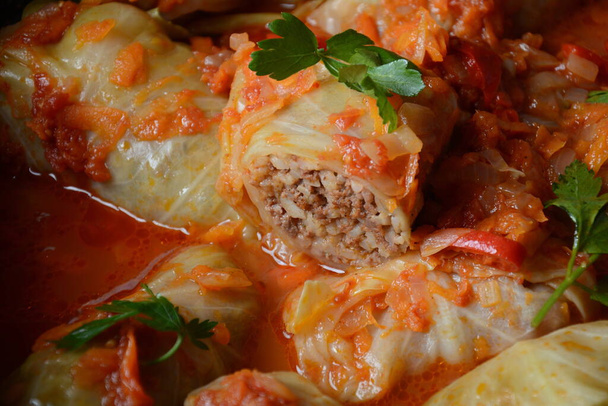 Cabbage rolls stuffed with ground beef and rice in tomato sauce - Photo, Image
