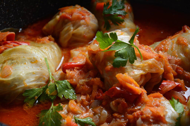 Cabbage rolls stuffed with ground beef and rice in tomato sauce - Photo, image