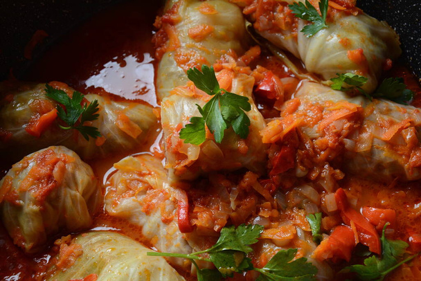 Cabbage rolls stuffed with ground beef and rice in tomato sauce - Photo, image