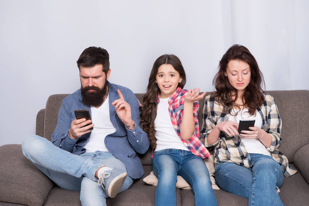 Smartphone ruining relations. Unhappy child complain of parents addicted to phones. Parents and child relations. Family relations and problems. Relations and relationship. Family values - Photo, image