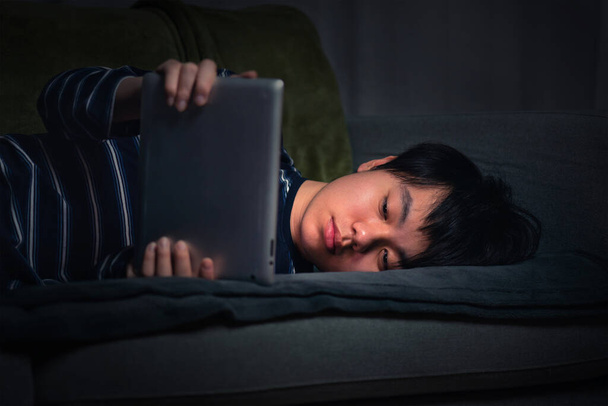 Young Asian boy gaming late at night - Foto, Bild