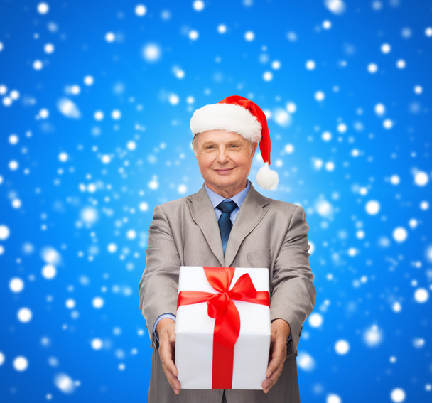 Smiling man in suit and santa helper hat with gift - Photo, Image